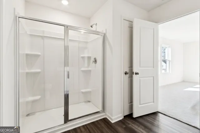 a bathroom with a glass shower door