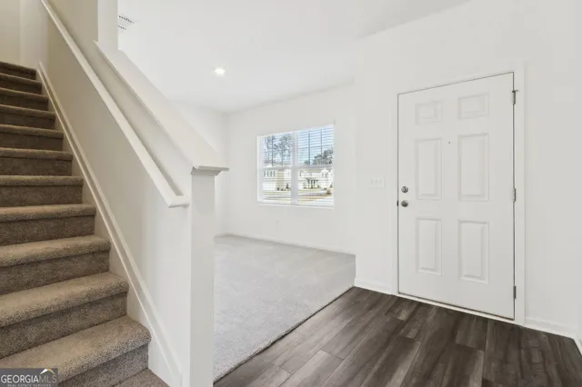 a view of an entryway with wooden floor