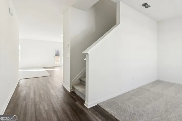 a view of hallway with wooden floor