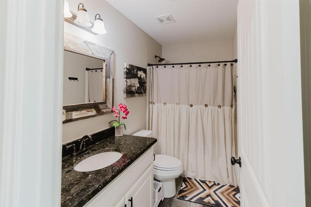 8615 North Fm 51 Decatur, TX 76234 - Photo 25 of 26 a bathroom with a granite countertop sink mirror vanity and toilet