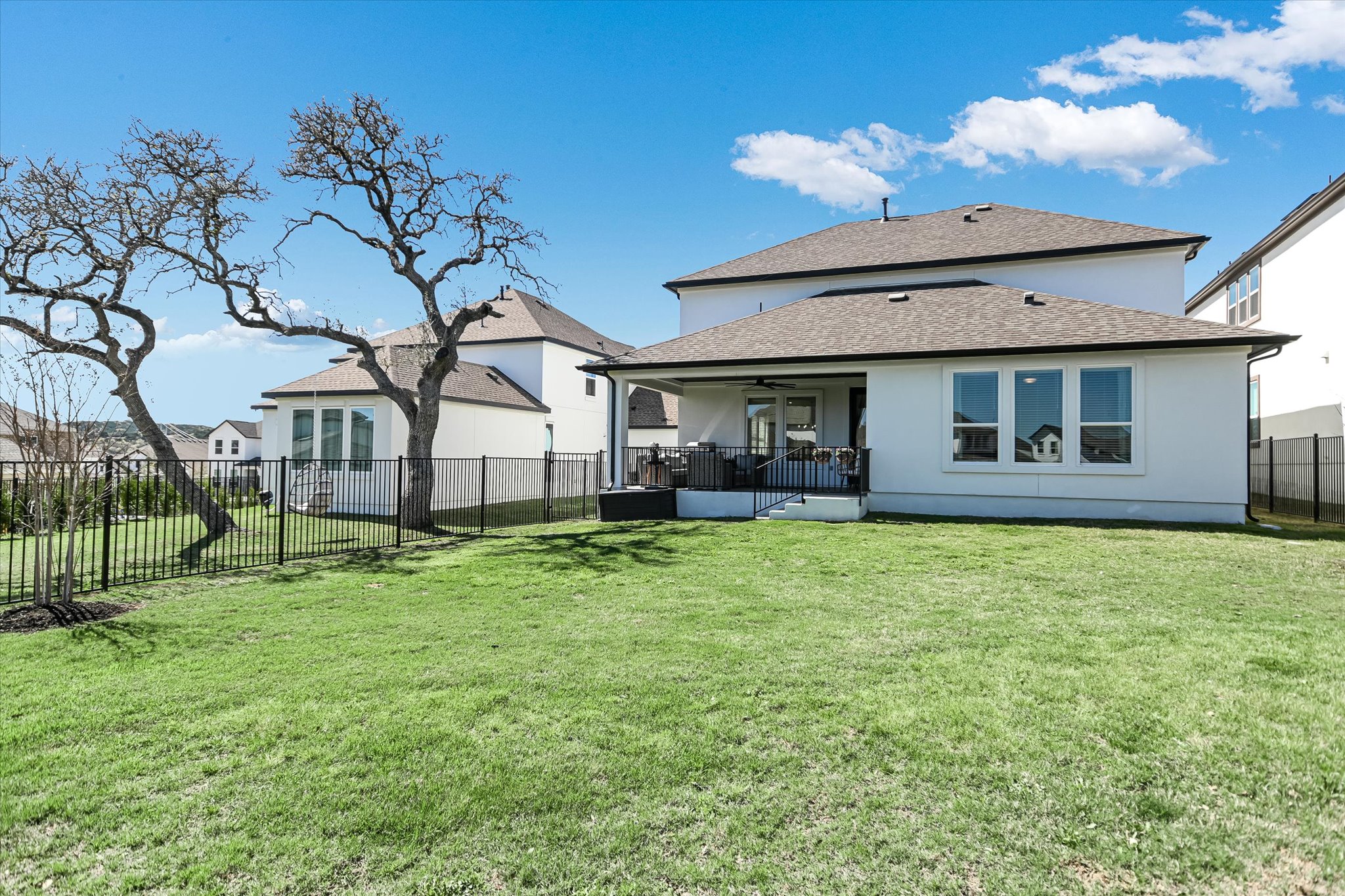 1928 Varese Path Leander, TX 78641 - Photo 20 of 31 The backyard is move-in ready with a full wrought- iron fence and 14 recently planted trees for future privacy.