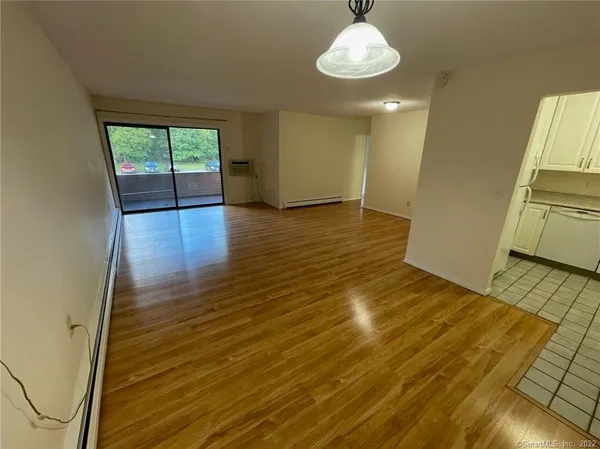 a view of a room with wooden floor and windows