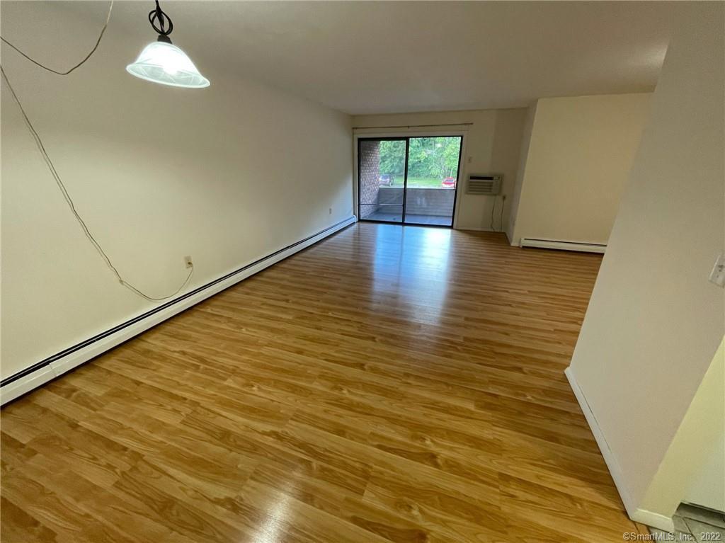 565 Talcottville Road, Unit 2B7 Vernon, CT 06066 - Photo 5 of 10 wooden floor in an empty room with a window
