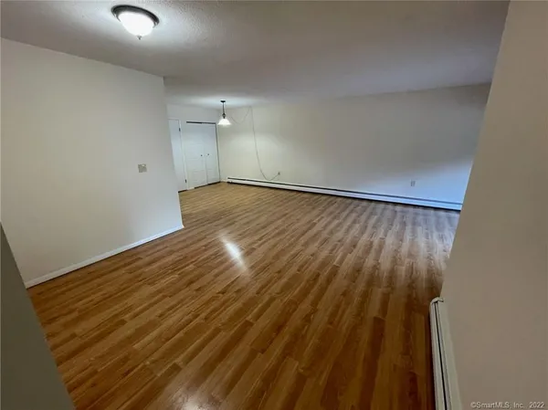 a view of wooden floor and brick walls