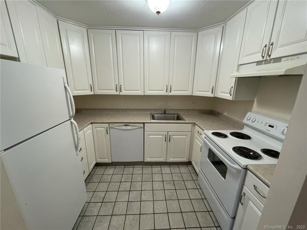 565 Talcottville Road, Unit 2B7 Vernon, CT 06066 - Photo 8 of 10 a kitchen with a sink stove and cabinets