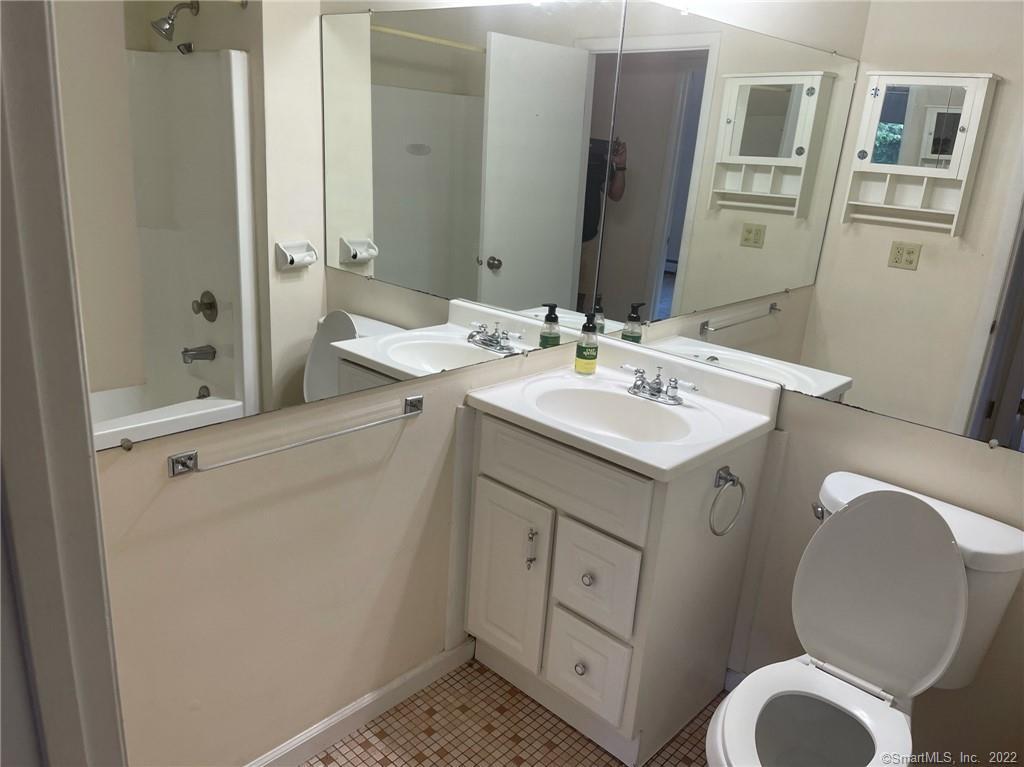 565 Talcottville Road, Unit 2B7 Vernon, CT 06066 - Photo 9 of 10 a bathroom with a toilet sink and mirror