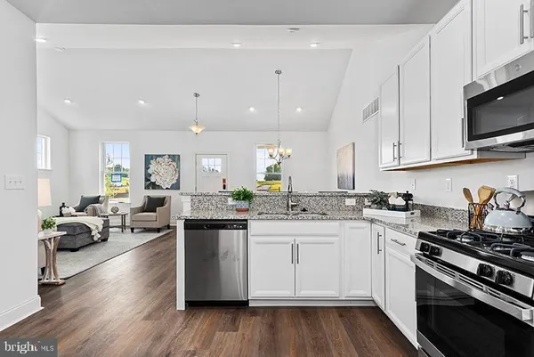 a kitchen with appliances a sink and cabinets