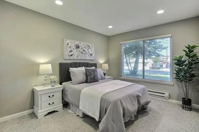 a spacious bedroom with a large bed and a window