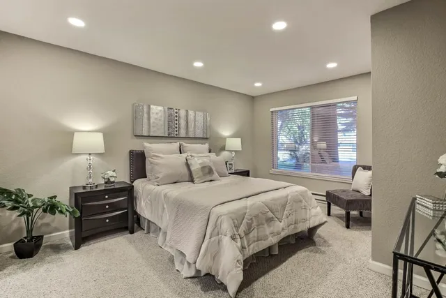 a bedroom with a bed and a table