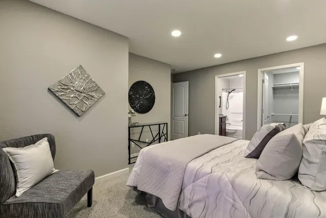 a bedroom with a bed and a lamp