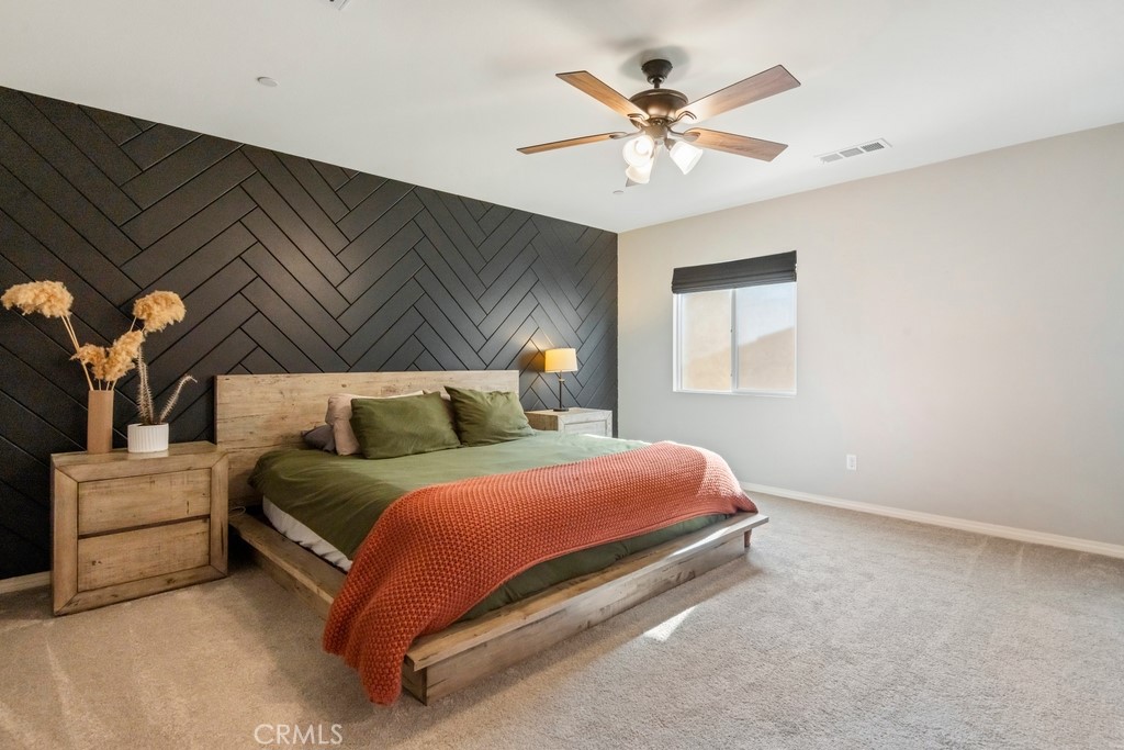 1148 Little Leaf Street Calimesa, CA 92320 - Photo 11 of 31 a bedroom with a bed and a chandelier