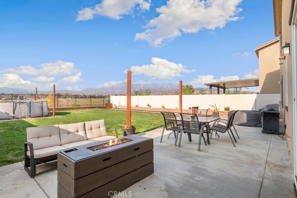 1148 Little Leaf Street Calimesa, CA 92320 - Photo 18 of 31 a view of a patio with couches potted plants and a big yard
