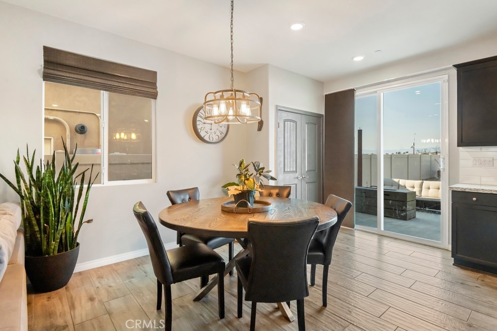 1148 Little Leaf Street Calimesa, CA 92320 - Photo 8 of 31 a dining room with furniture potted plants and wooden floor