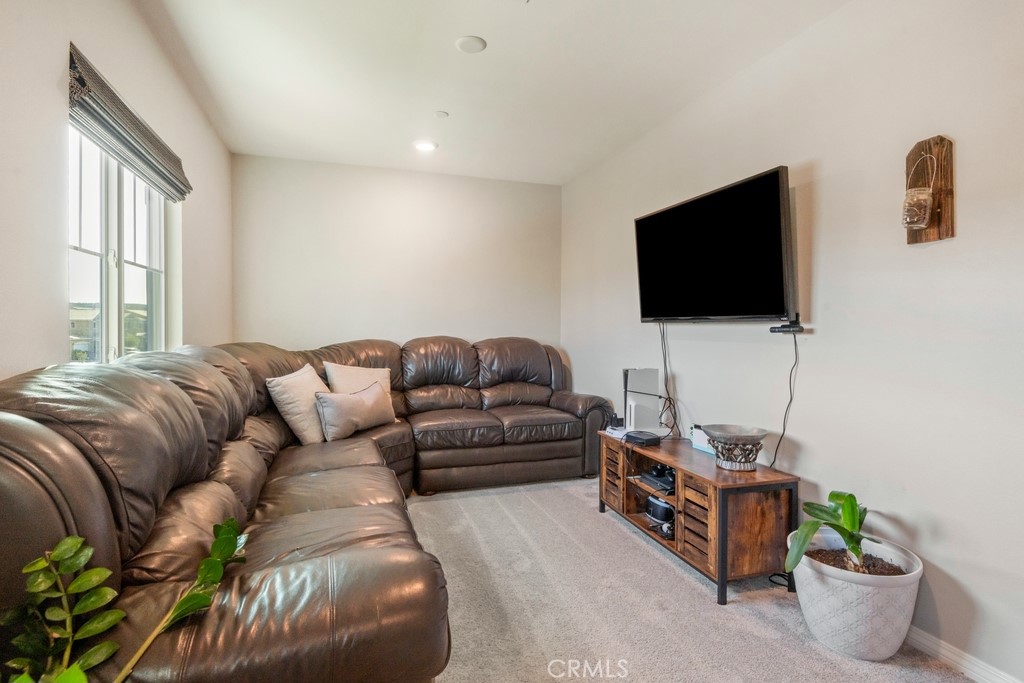 1148 Little Leaf Street Calimesa, CA 92320 - Photo 9 of 31 a living room with furniture and a flat screen tv