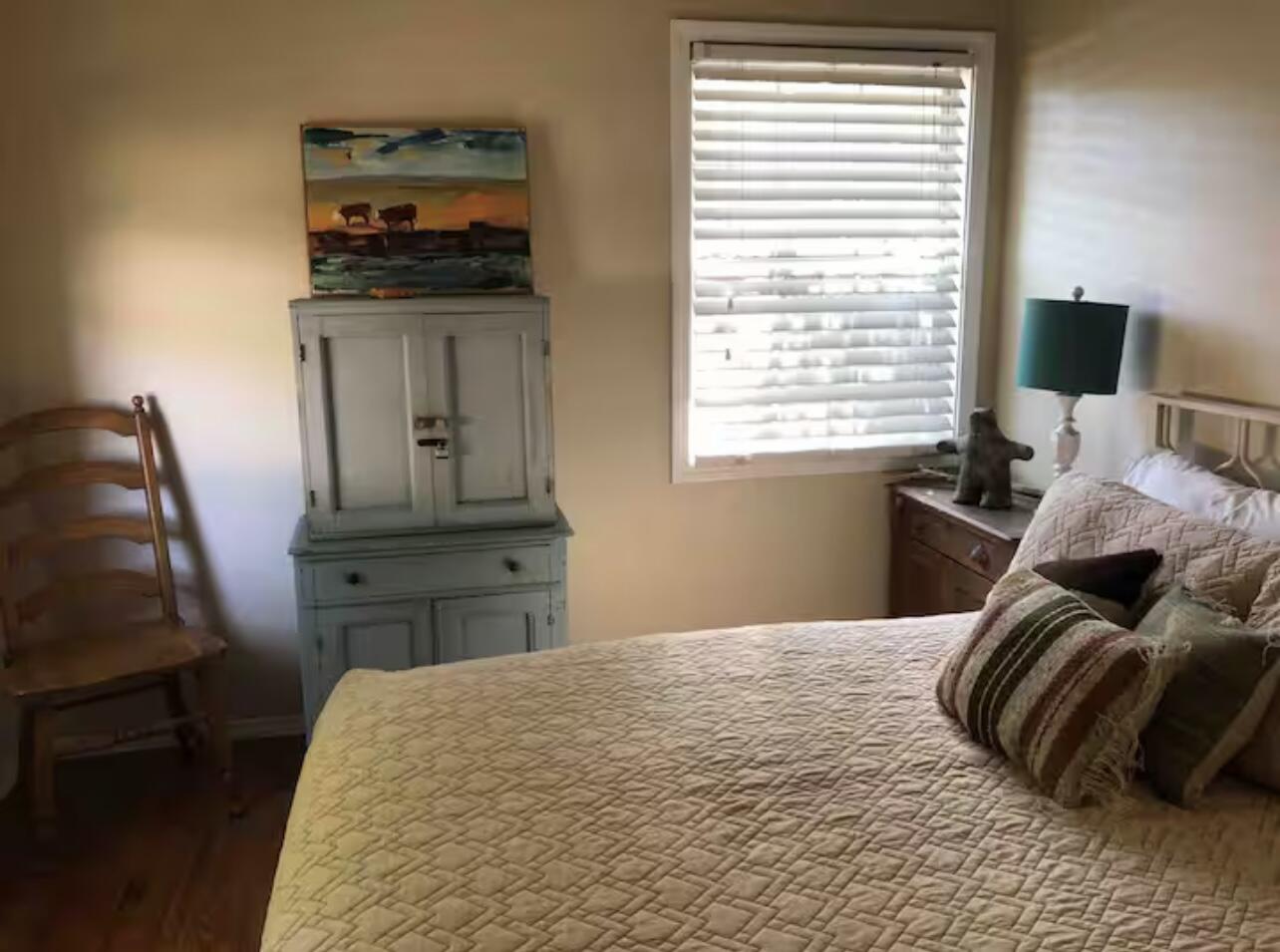 3621 31st Street Lubbock, TX 79410 - Photo 11 of 14 a bedroom with a bed and flat screen tv