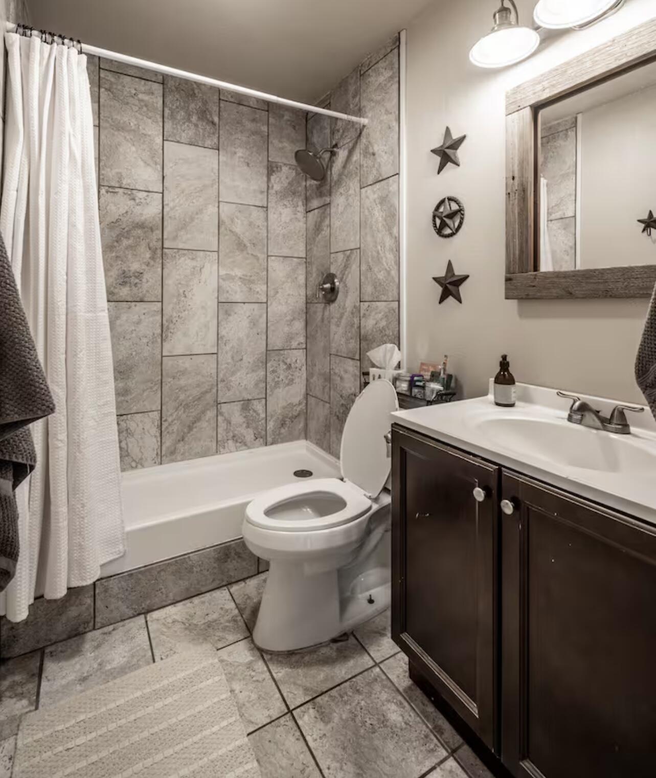 3621 31st Street Lubbock, TX 79410 - Photo 13 of 14 a bathroom with a sink toilet and shower