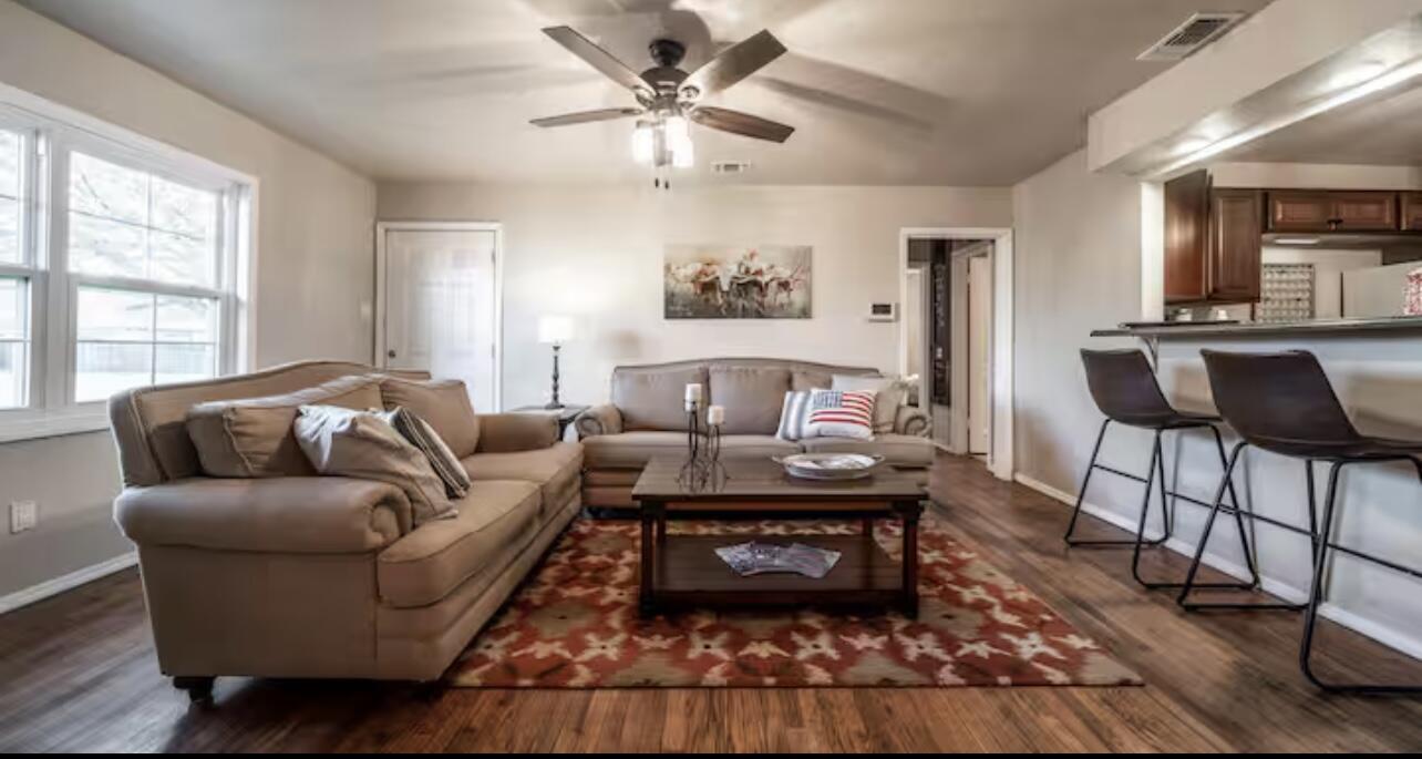3621 31st Street Lubbock, TX 79410 - Photo 3 of 14 a living room with furniture a rug and a window