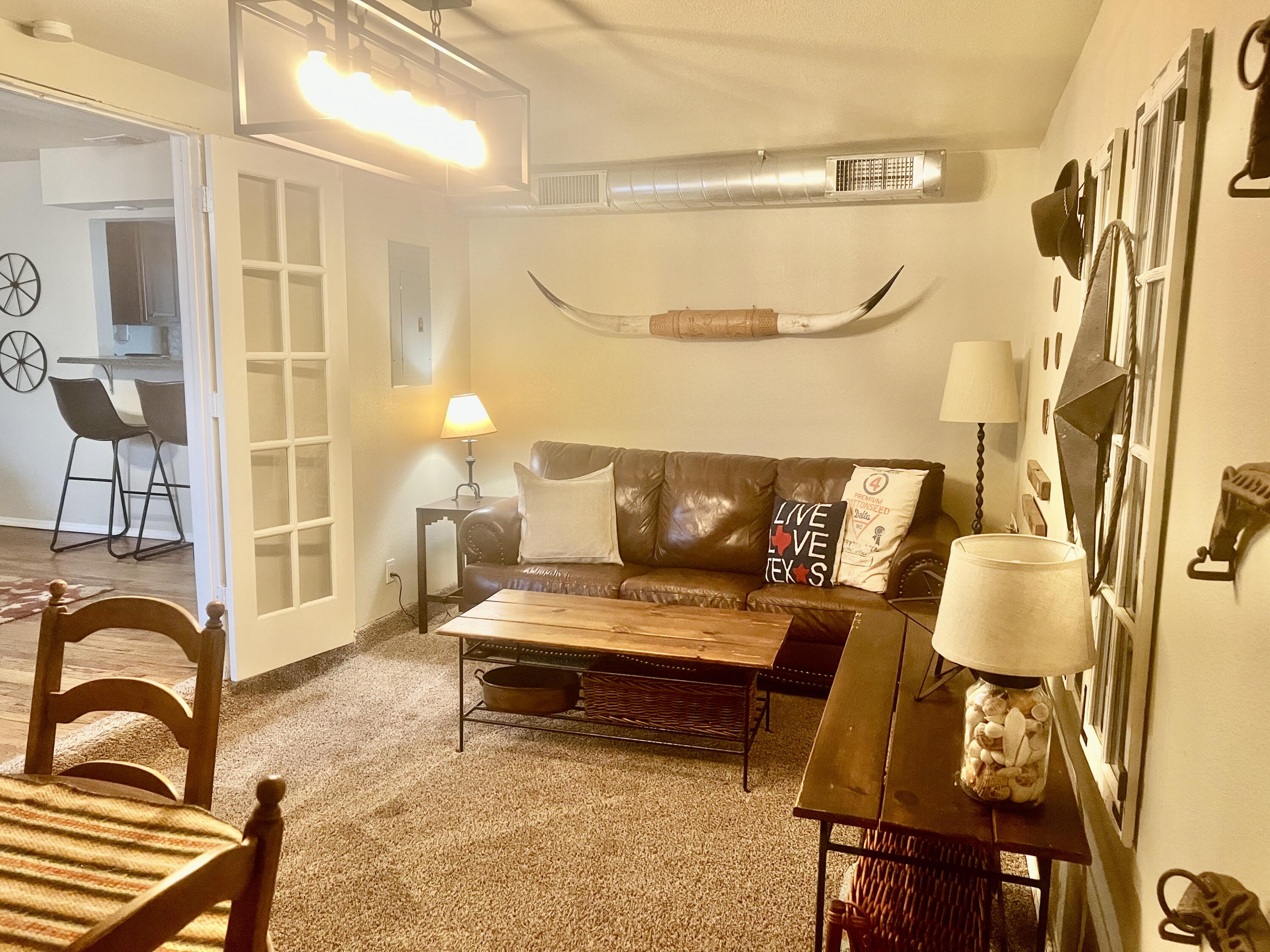 3621 31st Street Lubbock, TX 79410 - Photo 7 of 14 a living room with furniture and a fireplace