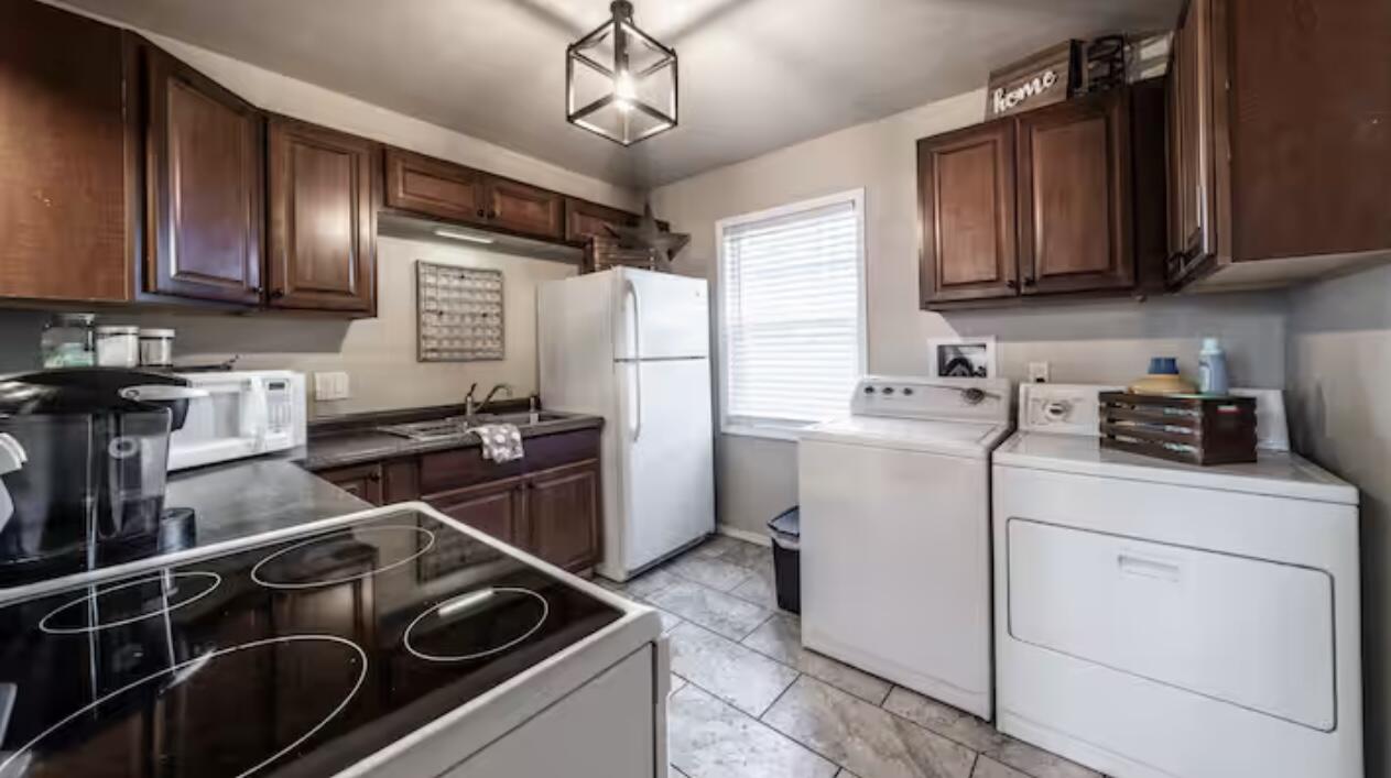3621 31st Street Lubbock, TX 79410 - Photo 9 of 14 a kitchen with a stove sink and cabinets