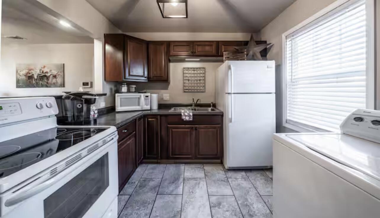 3621 31st Street Lubbock, TX 79410 - Photo 10 of 14 a kitchen with a sink a stove and refrigerator