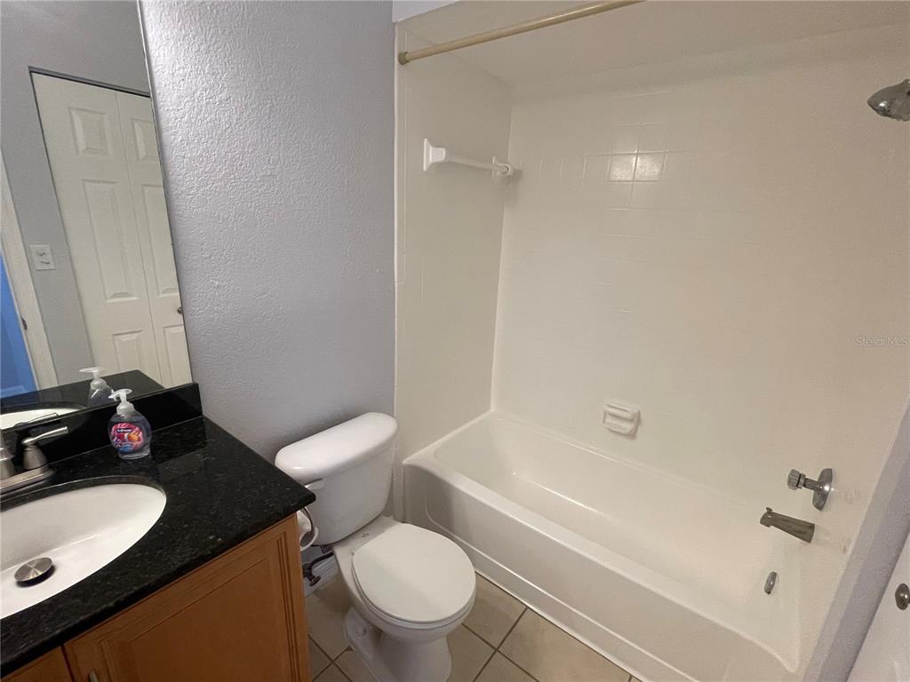 500 South Belcher Road, Unit 138 Largo, FL 33771 - Photo 12 of 31 a bathroom with a granite countertop sink toilet mirror and bathtub