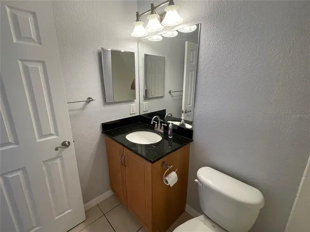 a bathroom with a sink toilet and mirror