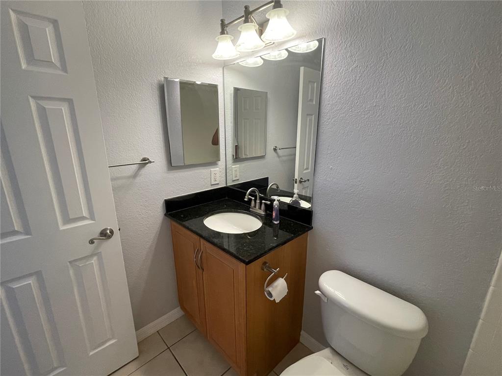 500 South Belcher Road, Unit 138 Largo, FL 33771 - Photo 13 of 31 a bathroom with a sink toilet and mirror
