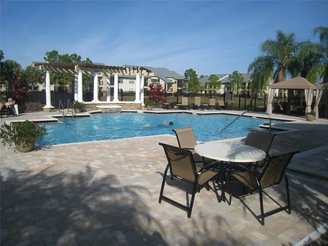 a view of a house with backyard patio and sitting area