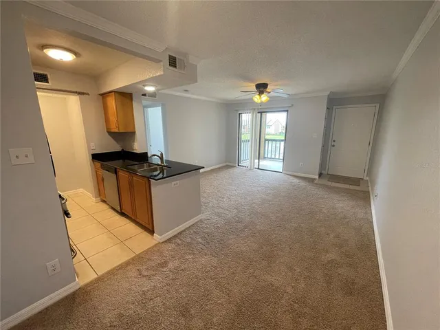 a view of a kitchen with furniture and windows