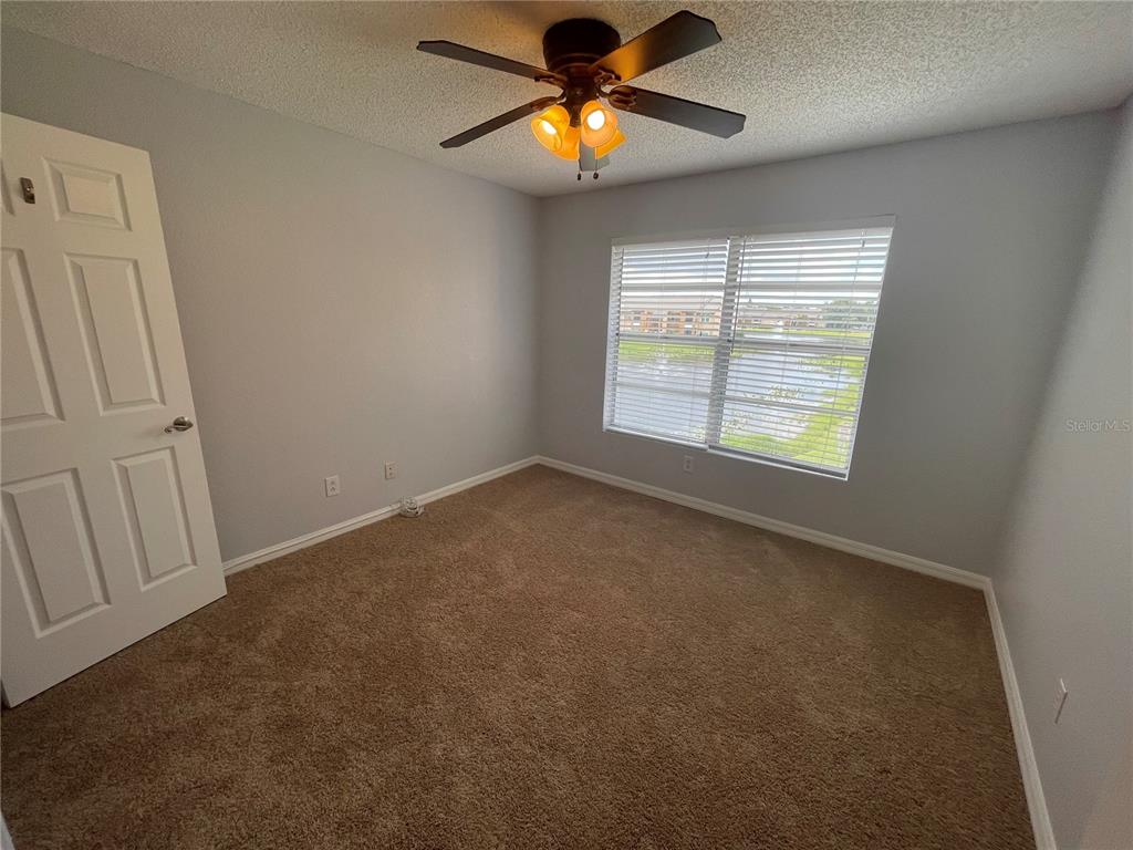 500 South Belcher Road, Unit 138 Largo, FL 33771 - Photo 8 of 31 an empty room with windows and chandelier fan