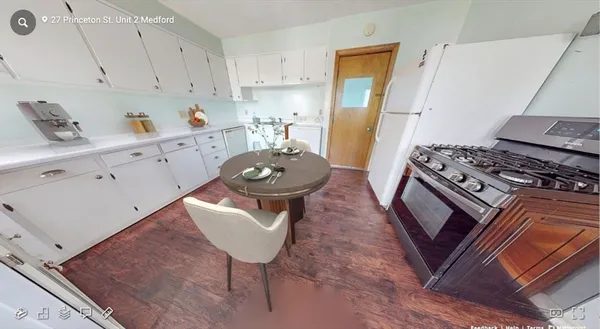 a kitchen with stainless steel appliances granite countertop a stove a sink dishwasher and cabinets with wooden floor