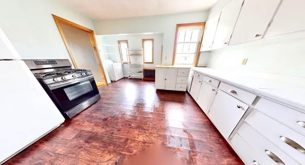 a kitchen with stainless steel appliances a stove a sink and a refrigerator