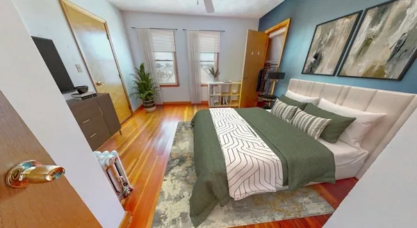 a bedroom with a bed and a mirror