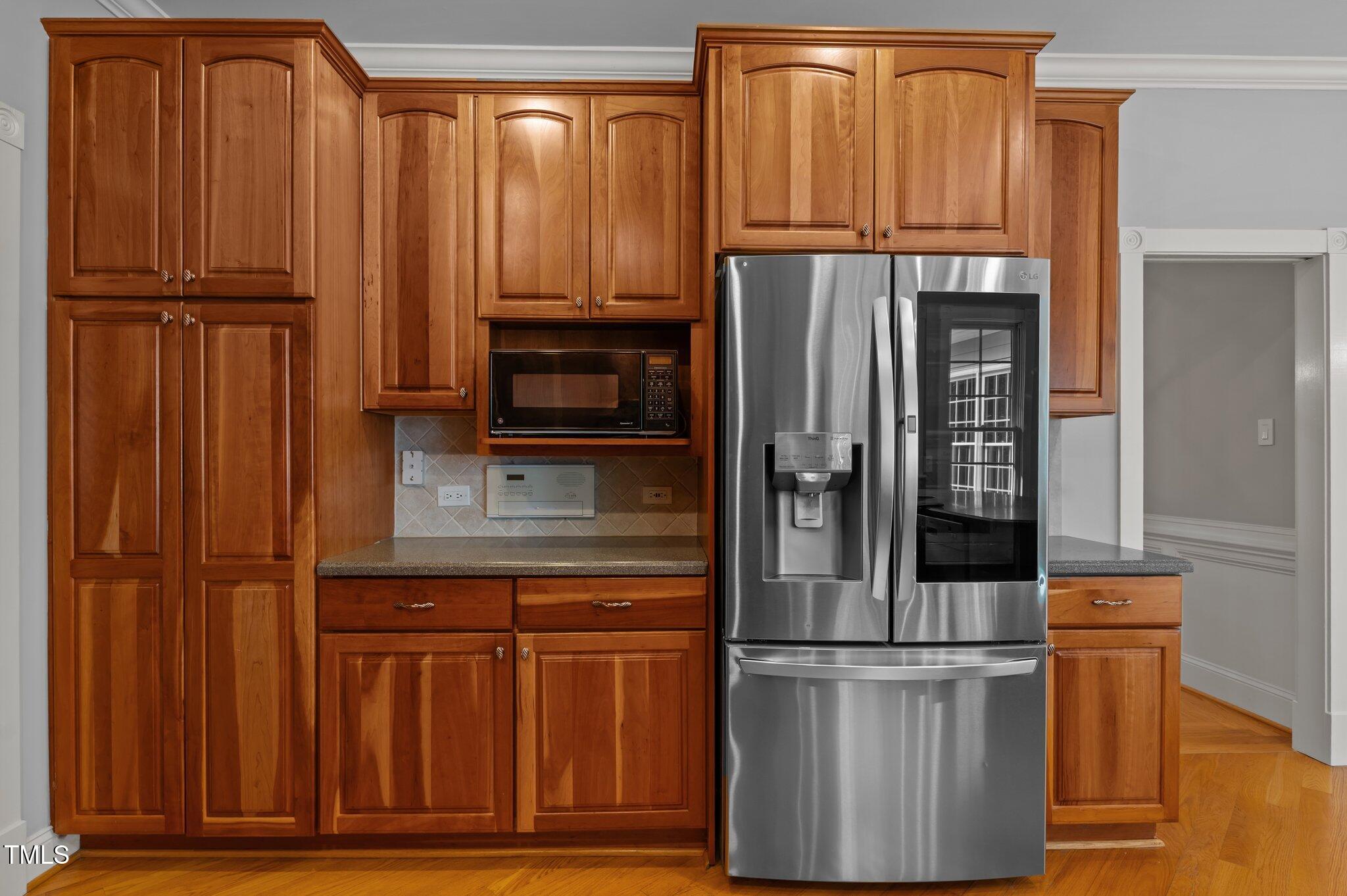 5344 Mill Dam Road Wake Forest, NC 27587 - Photo 30 of 68 a kitchen with stainless steel appliances granite countertop a refrigerator and cabinets
