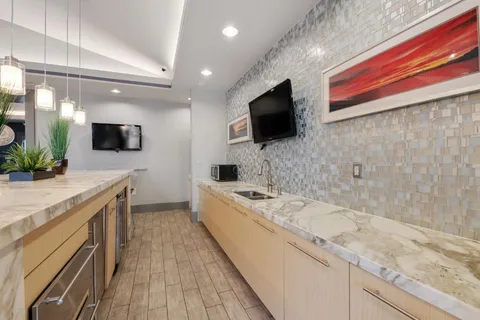 a spacious bathroom with a granite countertop double vanity and a mirror