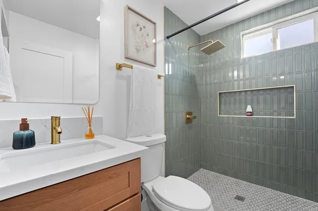 a bathroom with a sink toilet and shower