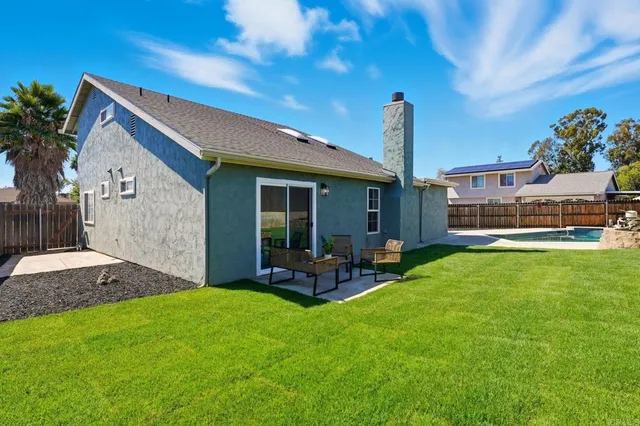 a front view of house with yard and outdoor seating