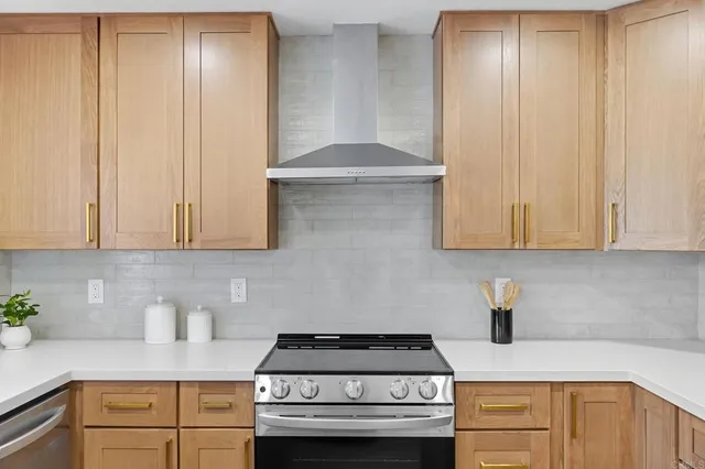 a kitchen with granite countertop cabinets stainless steel appliances and a counter space