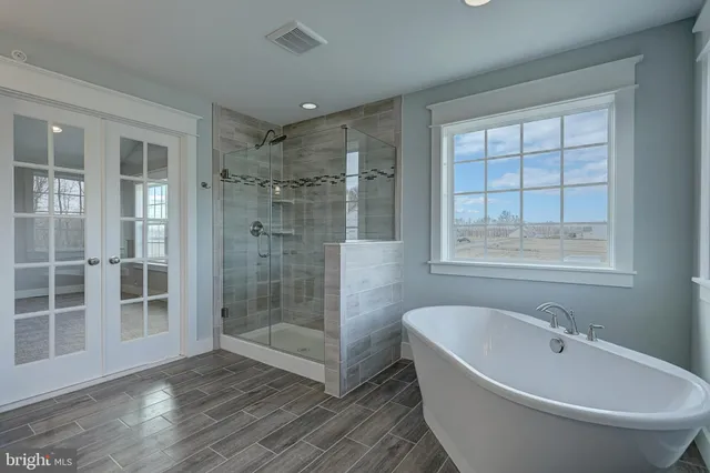 a white bath tub sitting next to a white sink