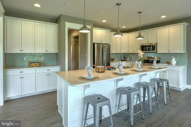 a living room with furniture a fireplace and a large window