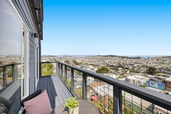 a view of a balcony with table and chairs