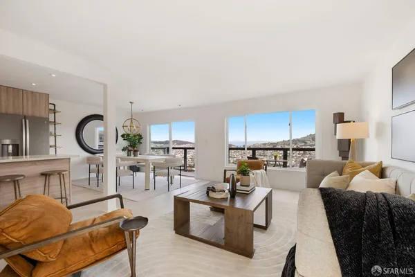 a kitchen with stainless steel appliances granite countertop a table chairs a stove a microwave a sink and a refrigerator