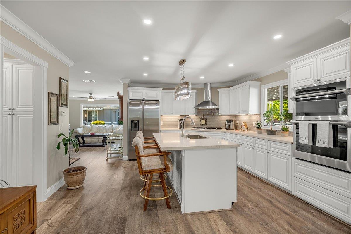 8 Spring Lane, Unit 8 Morgan Hill, CA 95037 - Photo 7 of 23 a kitchen with sink cabinets and wooden floor