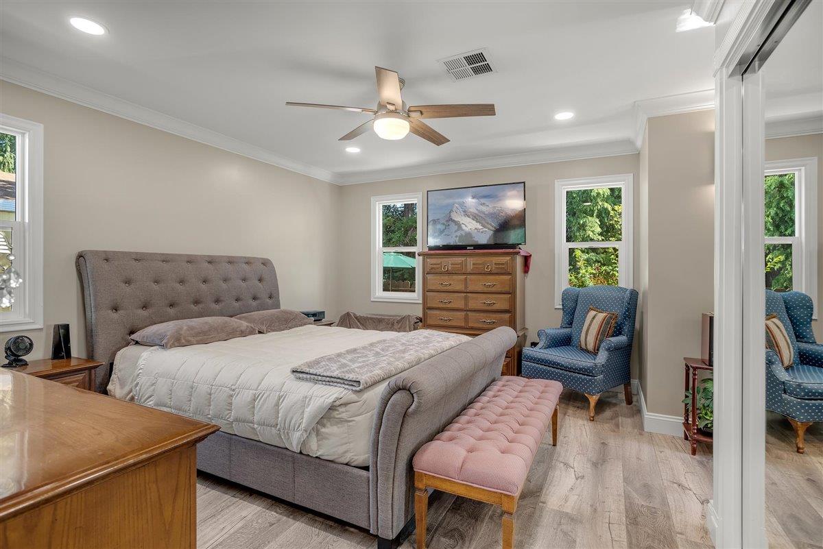 8 Spring Lane, Unit 8 Morgan Hill, CA 95037 - Photo 8 of 23 a bedroom with a bed and wooden floor