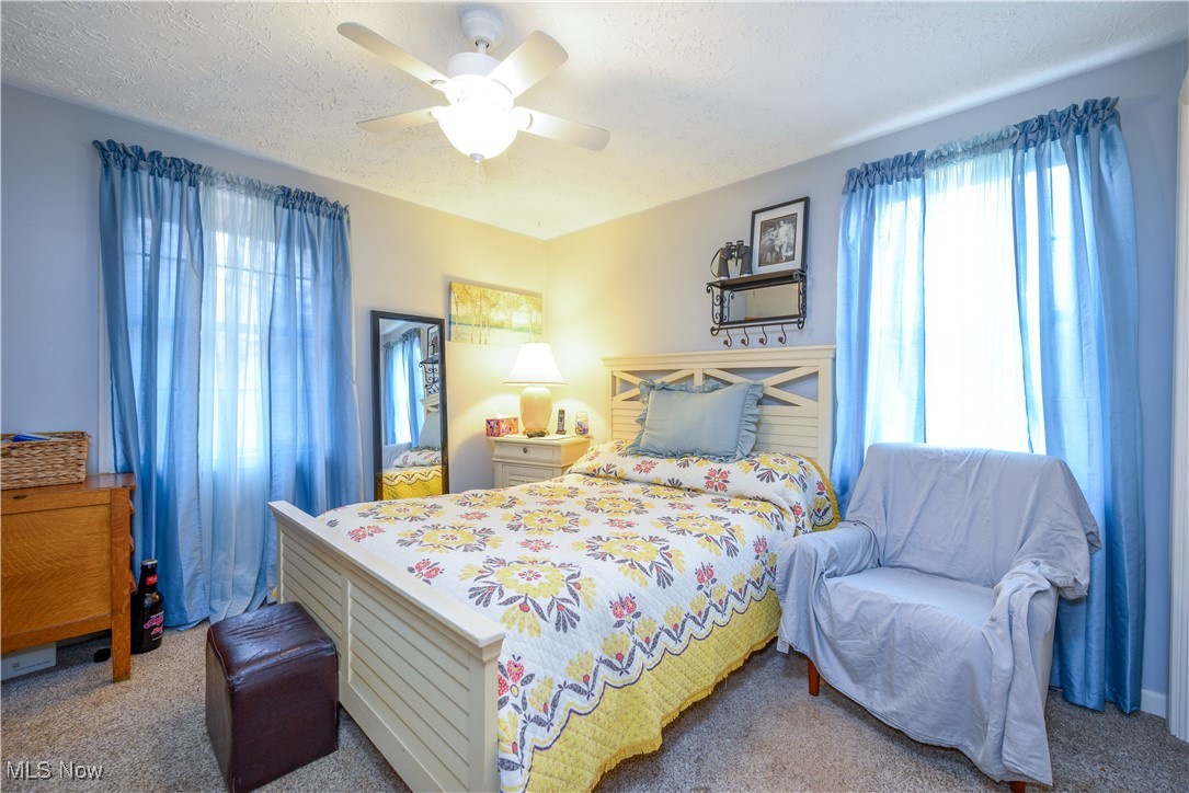 17080 Heiser Road Berlin Center, OH 44401 - Photo 32 of 35 Carpeted bedroom featuring ceiling fan, a textured ceiling, and multiple windows