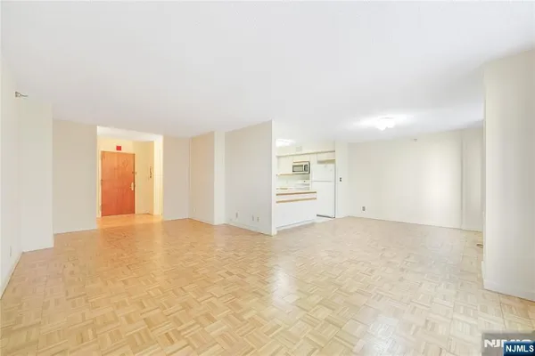 an empty room with closet and windows