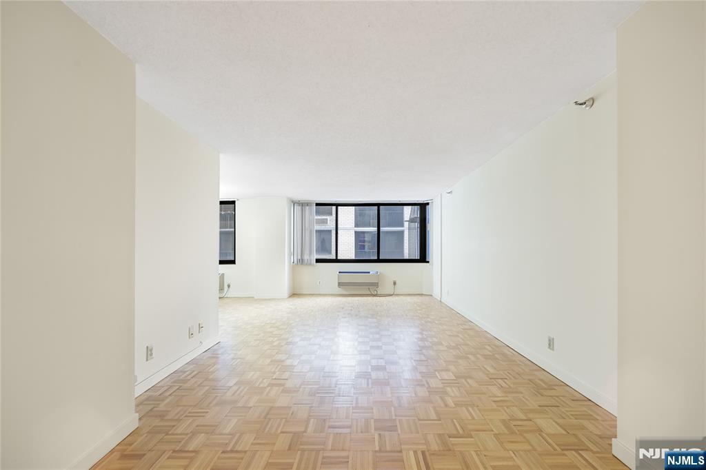 316 Prospect Avenue, Unit 3D Hackensack, NJ 07601 - Photo 13 of 20 a view of an empty room with a window and fireplace