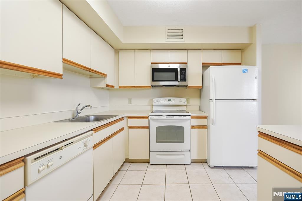 316 Prospect Avenue, Unit 3D Hackensack, NJ 07601 - Photo 17 of 20 a kitchen with a sink and a stove top oven
