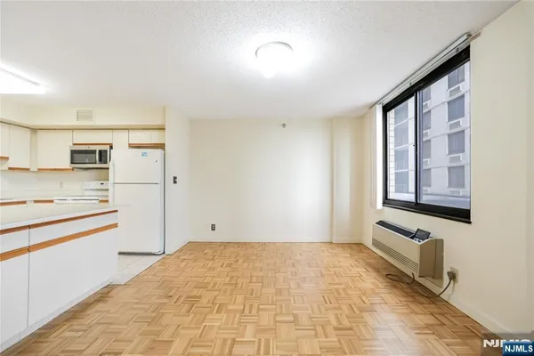 a view of a kitchen with an empty space and window