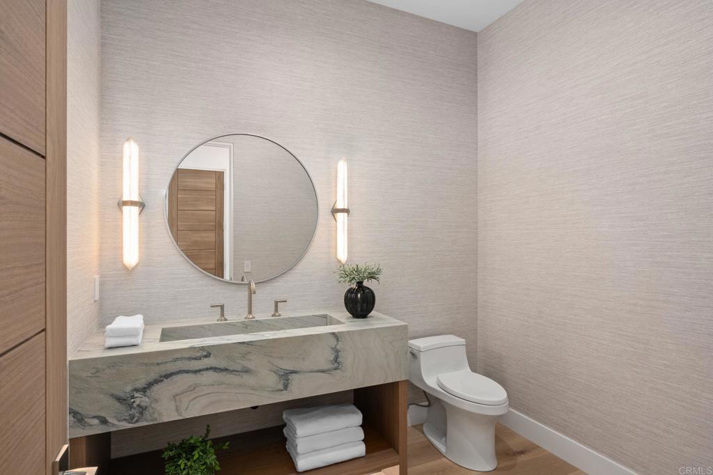 5471-73 La Crescenta Road Rancho Santa Fe, CA 92067 - Photo 15 of 23 a bathroom with a toilet a sink and mirror